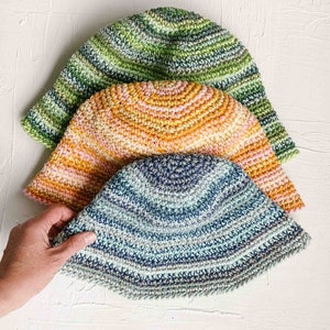 Three packable sunhat colors: blue, orange, and green.
