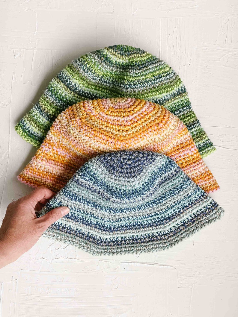 Three packable sunhat colors: blue, orange, and green.