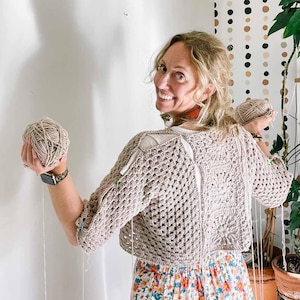 An in-progress hexagon cardigan worn by a woman.