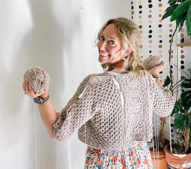 An in-progress hexagon cardigan worn by a woman.
