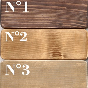 May include: Three wooden samples labeled with numbers, showing different shades of brown wood stain. The top sample is a dark brown, the middle sample is a medium brown, and the bottom sample is a light brown.