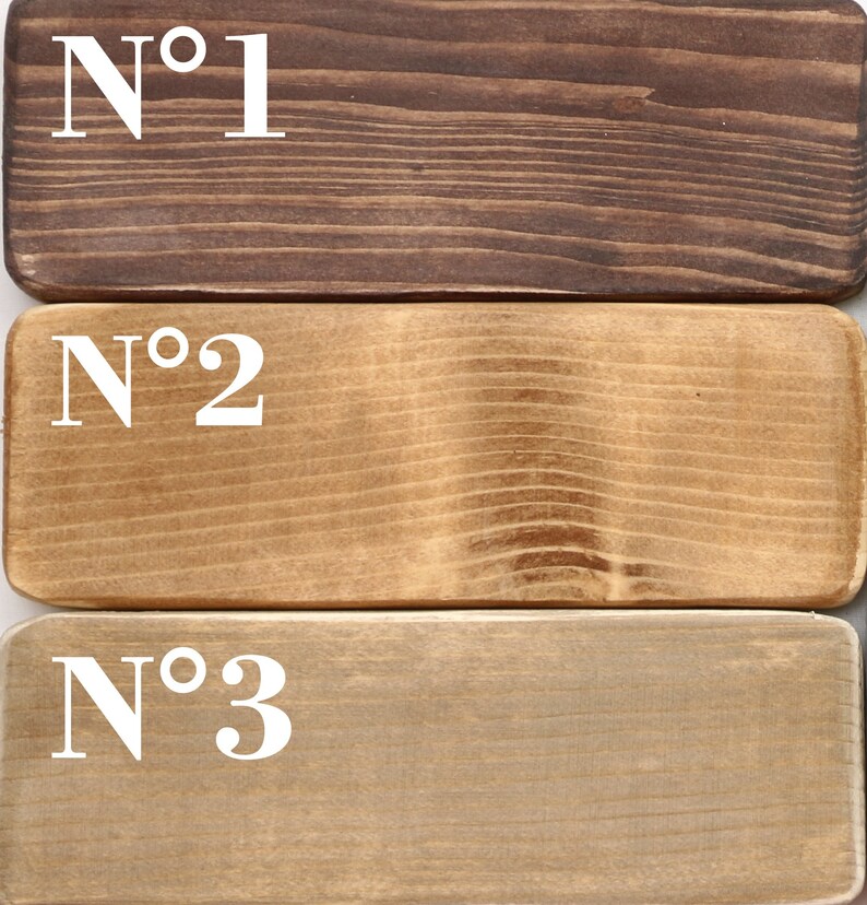 May include: Three wooden samples labeled with numbers, showing different shades of brown wood stain. The top sample is a dark brown, the middle sample is a medium brown, and the bottom sample is a light brown.