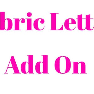 May include: White background with the words "Fabric Letter Add On" in bright pink, sans-serif font. The text is arranged in two lines, with "Fabric Letter" on top and "Add On" below.