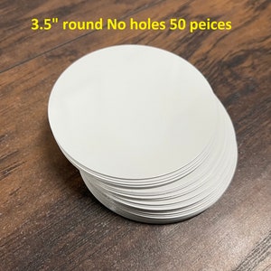 May include: A stack of 50 white, 3.5 inch round paper circles with no holes.