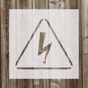 May include: A white stencil of a yellow triangle with a lightning bolt inside. The triangle has a black outline and a black base.