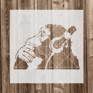 May include: A black and white stencil of a monkey wearing headphones. The monkey is looking to the right and has its mouth open.