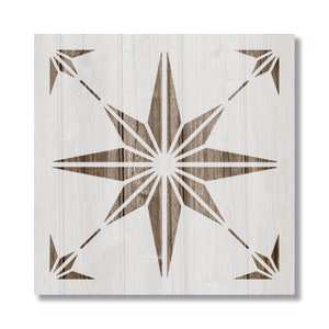 May include: A white wooden square with a brown starburst design cut out. The starburst has eight points and is centered on the square.
