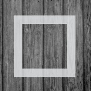 May include: A white square frame is centered on a wood panel background. The frame is outlined in white and is empty.