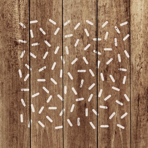 May include: White painted lines on a brown wooden background. The lines are arranged in a random pattern, creating a modern and abstract design.
