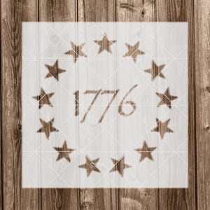 May include: A white stencil with a circle of stars and the number 1776 in the center.