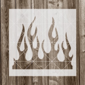 May include: White stencil of a flame design with five flames. The stencil is on a wood background.