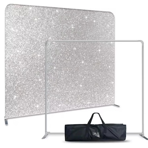 May include: A silver glitter backdrop with a stand and a black carrying case. The backdrop is made of fabric and is perfect for photography or video backdrops.