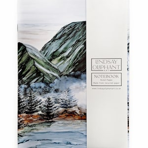 Pode incluir: Caderno com pintura de paisagem de montanhas, árvores e água. A capa apresenta uma cena de montanha em tons de verde, azul e castanho. A lombada inclui o texto "LINDSAY OLIPHANT ART" e "NOTEBOOK".