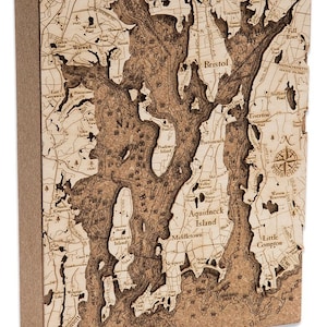 May include: A detailed wooden map of the Narragansett Bay area in Rhode Island. The map features the names of towns and cities, including Newport, Middletown, Bristol, and Warwick. The map also shows the location of various bodies of water, including the bay itself, the Sakonnet River, and the Taunton River.