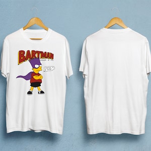 May include: White t-shirt with a cartoon image of Bart Simpson as "Bartman" and the text "BARTMAN AVENGER OF EVIL" in red and yellow. Bart is wearing a purple cape and has a speech bubble saying "Watch it, Dude."