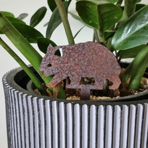 Miniature Australian-made corten (rusty) wombat pot plant stake.