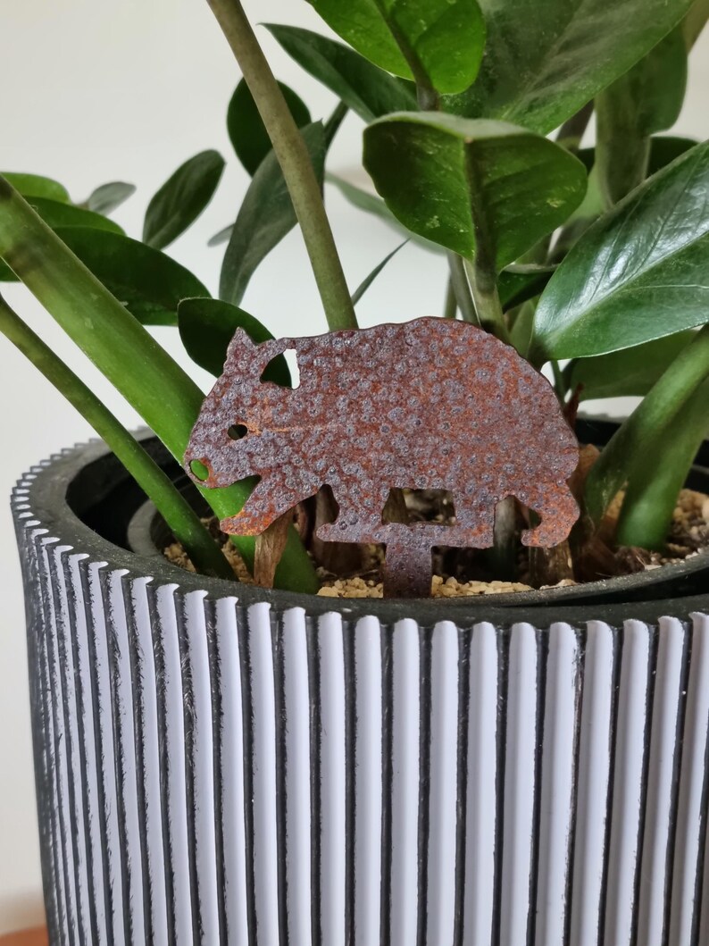 Miniature Australian-made corten (rusty) wombat pot plant stake.