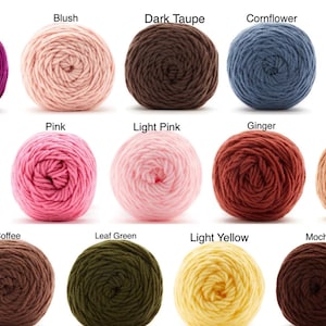 May include: A collection of yarn balls in various colors, including raspberry, blush, dark taupe, cornflower, light coral, navy, pink, light pink, ginger, bisque, coffee, leaf green, light yellow, and mocha. Each ball is labeled with its color name.