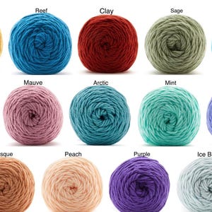 May include: A collection of fifteen yarn balls in various colors, including mustard, reef, clay, sage, aqua, blue, mauve, arctic, mint, periwinkle, bisque, peach, purple, and ice blue. Each ball is tightly wound, showcasing the texture of the yarn.