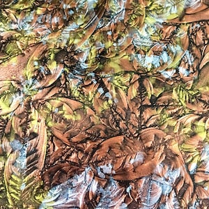 May include: Abstract artwork featuring a textured surface with a repeating leaf pattern. The color palette includes shades of brown, copper, yellow, and silver, creating a metallic effect. The design has a raised, embossed appearance.