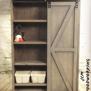 Tall barn door cabinet with bottom shoe storage area
