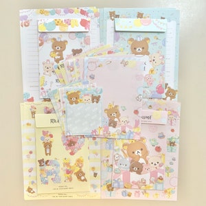 Paquete de muestra de hojas de notas y cartas "Happy For You" de San-X 2023 con texto en inglés "Rilakkuma".