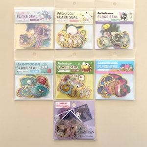 May include: A collection of colorful flake seal sticker packs featuring various cartoon characters. Each pack contains 30 stickers and includes characters like Pochacco, Bad Badtz-maru, and Hangyodon. The stickers are in clear plastic packaging.