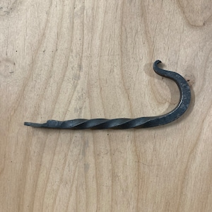 Hand forged hook with a twist