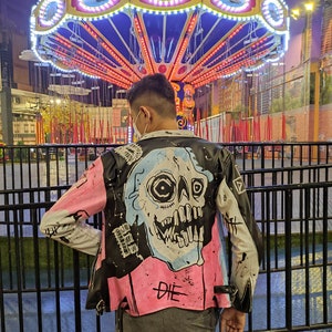 the appearance of a person wearing a painted jacket in front of a merry-go-round