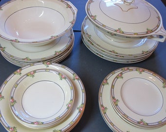 May include: A set of vintage china dinnerware with a floral pattern. The set includes a large serving bowl with a lid, a set of plates, and a set of bowls.