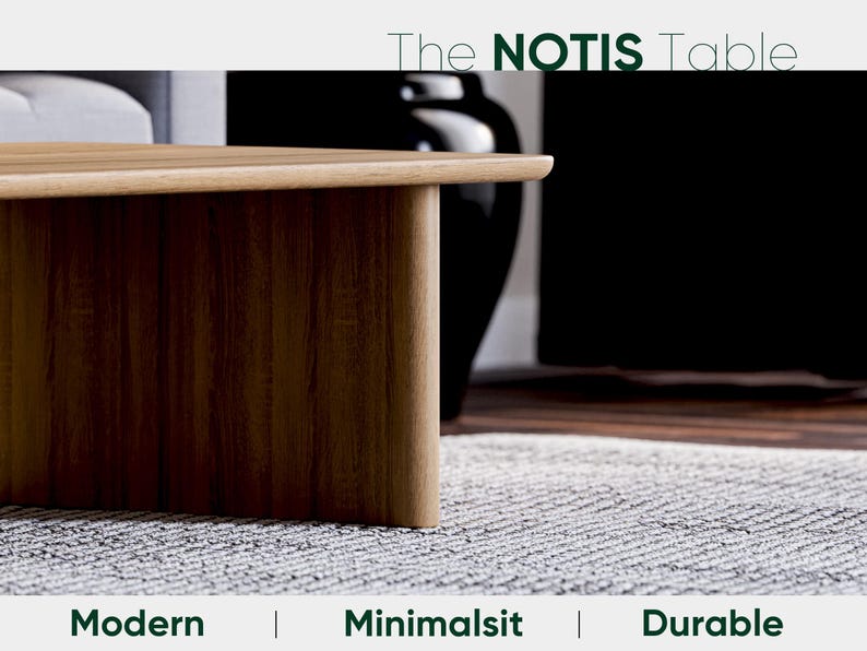 May include: The NOTIS Table, a modern and minimalist wooden table with a warm brown finish. The table's design features a rounded edge and a sturdy, durable construction. The image also includes a black vase and a gray rug.