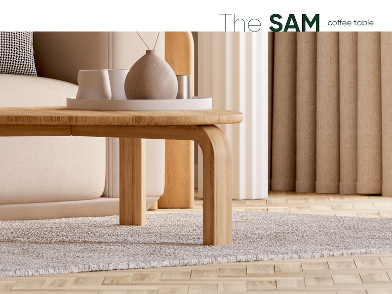 May include: A light wood coffee table with rounded edges and curved legs. The table supports a white tray with white cups and a decorative vase. The text "The SAM coffee table" is in the upper right corner. The table sits on a gray rug.