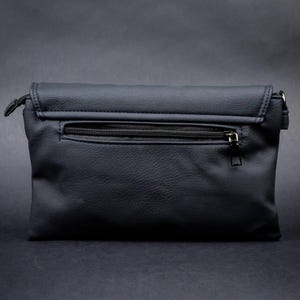 Rear view of the GOTHX black vegan leather bag with zip pocket for secure storage. Styled on a dark gothic background.
