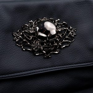 Close-up of silver skull motif on CHOK GothX gothic black vegan leather bag.