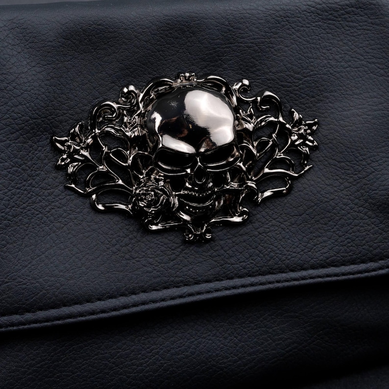 Close-up of silver skull motif on CHOK GothX gothic black vegan leather bag.