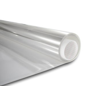 May include: A roll of clear, transparent adhesive film. The film is rolled up and has a white backing.