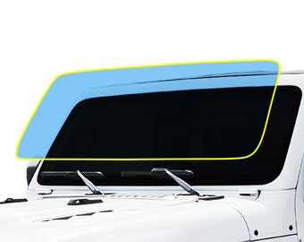 May include: A white Jeep Wrangler with a black windshield and a blue tinted windshield sunshade.