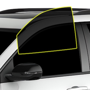 May include: A close-up of a car's tinted window. The window is curved and has a black frame. The window is tinted dark, making it difficult to see inside the car.