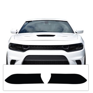 May include: A pair of black headlight covers for a white Dodge Charger. The covers are designed to give the headlights a smoked or blacked-out look.