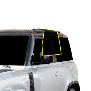 May include: A silver SUV with black tinted windows. The rear passenger window is partially open.