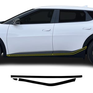 May include: A white SUV with black trim and yellow accent lines. The image also shows a set of black trim pieces, likely for installation on the vehicle. The car has tinted windows and a sleek, modern design.