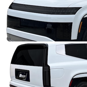 May include: Close-up of a white vehicle's front and rear sections. The front features a black grille and bumper, with a black strip across the top. The rear shows a black window and a Gear Tech Designs logo.