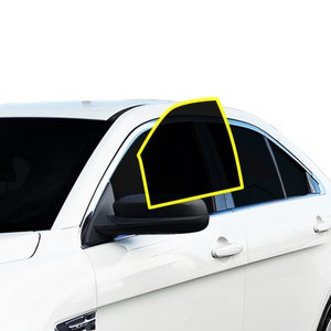 May include: A white saloon car with tinted windows. The driver's side window is rolled down and the side mirror is visible.