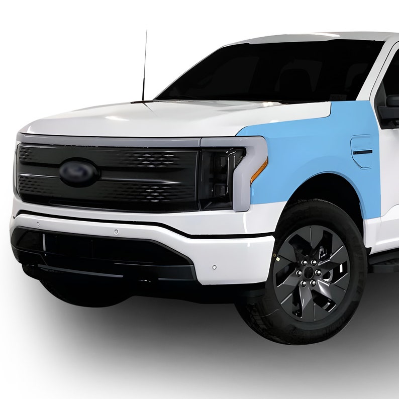 May include: A white pickup truck with a black grille and headlights. The truck has a blue protective film on the front fender.