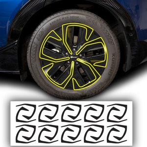 May include: A set of 10 black and white wheel rim stickers. The stickers feature a stylized swirl design. The stickers are designed to be placed on the rim of a car wheel.