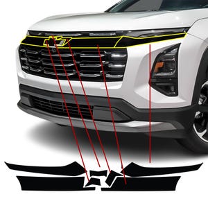 May include: A white car's front end with a black grille and a yellow outline highlighting the Chevrolet emblem. The image also shows black vinyl pieces designed to fit the car's front.