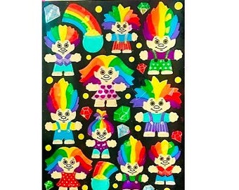 May include: A sheet of rainbow-colored troll stickers with the text "Sandylion Sticker Designs".