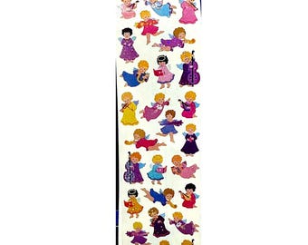 May include: A vertical sheet of stickers featuring numerous small illustrations of angels with blonde hair and colorful wings. The angels are depicted in various poses, including playing musical instruments like cellos, violins, and harps, or holding books.