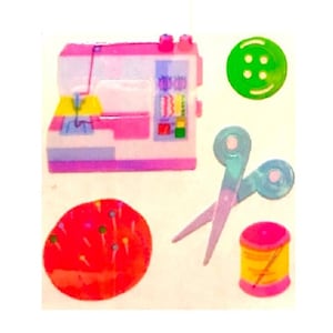 May include: A set of colorful sewing themed stickers featuring a pink sewing machine, a red pincushion, a green button, a spool of thread, and a pair of blue scissors.