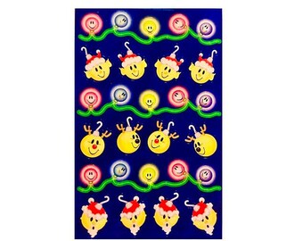 May include: A sheet of stickers on a dark blue background featuring rows of holiday-themed graphics. The design includes strings of colorful glowing light bulbs with smiley faces, yellow elf heads wearing red Santa hats, and yellow reindeer heads.
